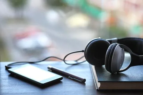 A stack of textbooks headphone Stock Photos