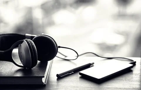 A stack of textbooks with headphone Stock Photos