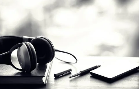 A stack of textbooks with headphone Stock Photos