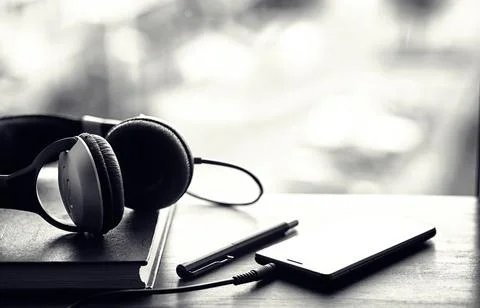 A stack of textbooks with headphone Stock Photos