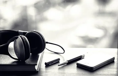 A stack of textbooks with headphone Stock Photos