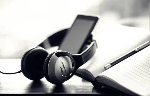 A stack of textbooks with headphone Stock Photos