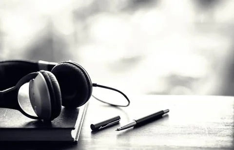 A stack of textbooks with headphone Stock Photos