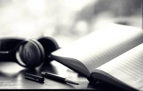 A stack of textbooks with headphone Stock Photos