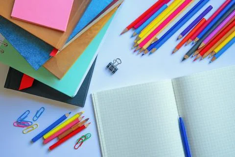 Stack of textbooks, open workbook and colored pencils. Copy space Stock Photos