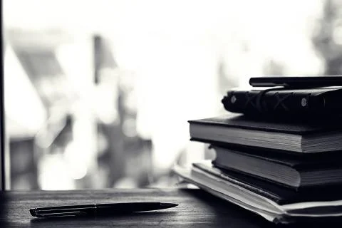 A stack of textbooks on a table Stock Photos