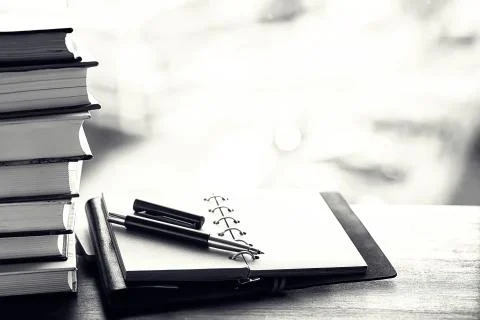 A stack of textbooks on a table 스톡 사진