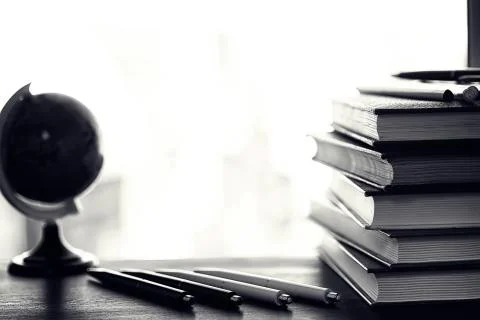 A stack of textbooks on a table Stock Photos