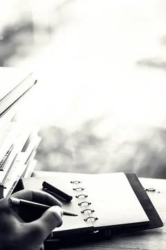 A stack of textbooks on a table Stock Photos