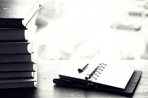 A stack of textbooks on a table Stock Photos