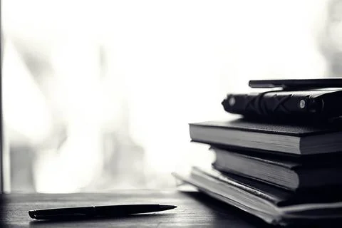 A stack of textbooks on a table 写真素材