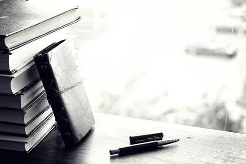 A stack of textbooks on a table Stock Photos