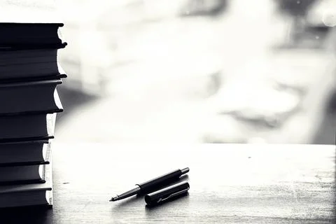 A stack of textbooks on a table Stock Photos