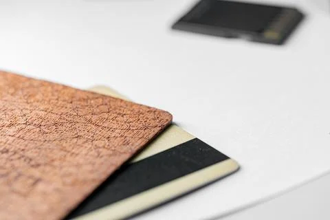 Stack of textured brown, black, and white cards on white surface Stock Photos