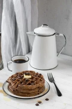 Stack of thick chocolate waffles with butter and syrup Stock Photos