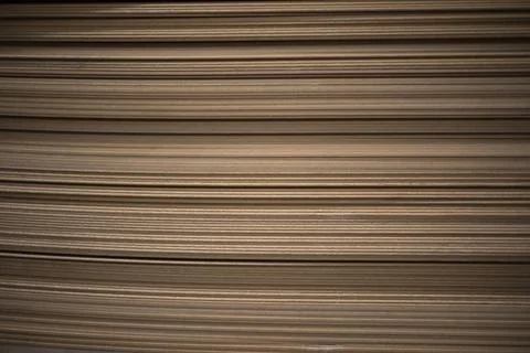 A stack of thin boards. Construction material. Product made from sawdust. Stock Photos