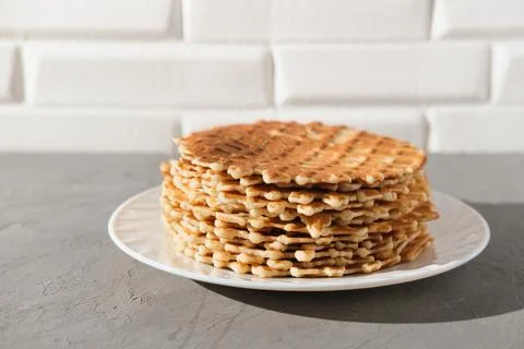 Stack of thin round waffels on white plate. fresh baked homemade simple waffers Stock-Fotos