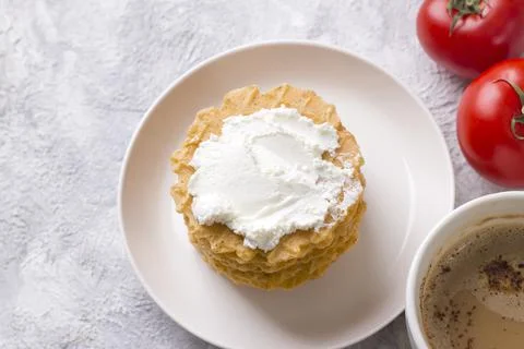 A stack of thin salty waffles with creamy sauce Stock Photos