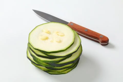 Stack of thin slices of fresh zucchini on a white background 스톡 사진