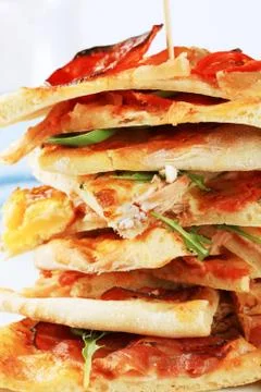 Stack of thin slices of pizza - detail Stock Photos