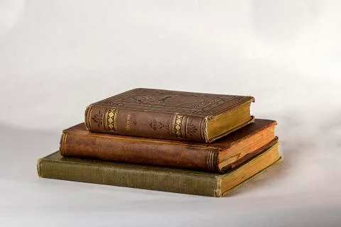 Stack of Three Antique books on a white background. Stock Photos