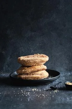 A stack of three apple beignets (apple fritters) on black background, no peop 写真素材