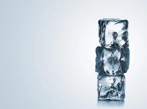 Stack of three blue ice cubes with copyspace 스톡 사진