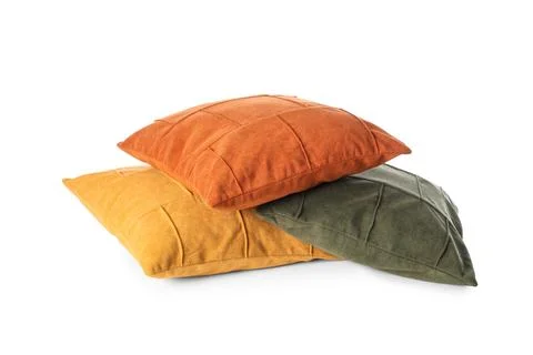 Stack of three colorful decorative throw pillows in orange, yellow, and olive Fotos de archivo