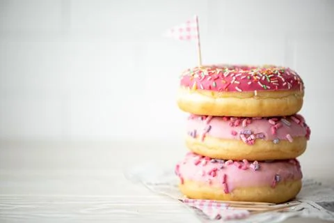 A stack of three donuts in glaze Foto stock