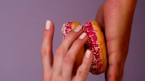 Stack of three Donuts in Male Hand. Woman taking Donut step by step. Pink Stock Footage 287562955