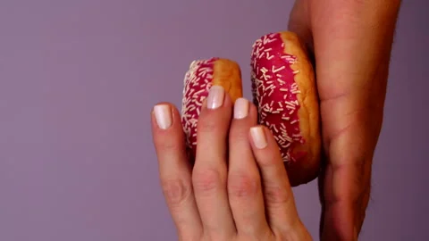 Stack of three Donuts in Male Hand. Woman putting Donut step by step on Stock Footage 287563010