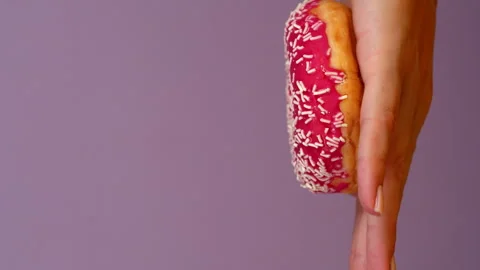 Stack of three Donuts Stop motion animation on female hand. Pink Doughnut Stock Footage 287582512