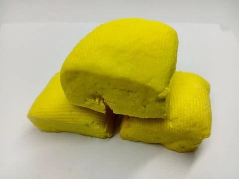 Stack of Three Fresh Yellow Tofu Blocks on White Background 写真素材