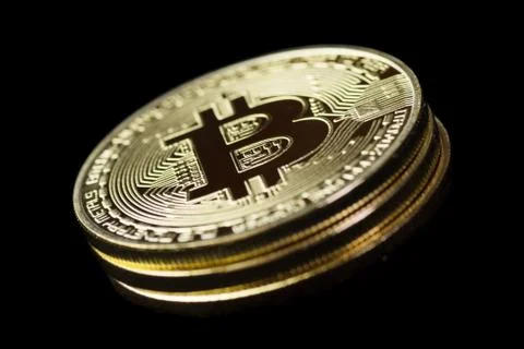 Stack of three golden Bitcoins on black background Stock Photos