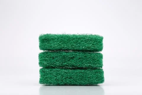 Stack of three green abrasive scrubber pads for home and kitchen isolated on Stock Photos