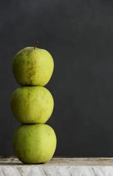 Stack of three green apples Stock Photos