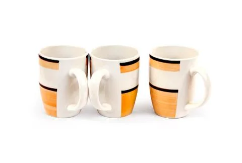 Stack of three mugs isolated on white background with clipping path Stock Photos