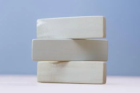 Stack of three natural wooden rectangles isolated on blue backdrop. Perfect t Stock Photos