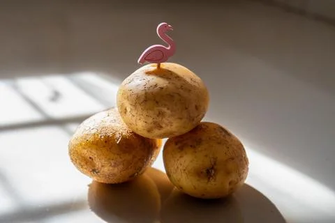 A stack of three raw potatoes decorated Stock Photos