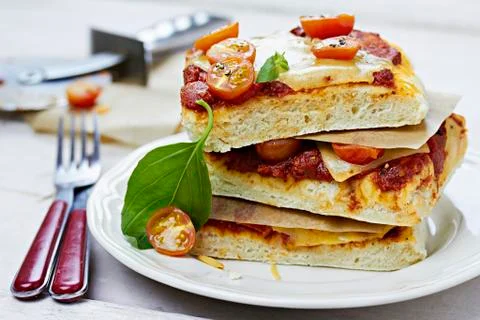 A stack of three slices of pizza 스톡 사진