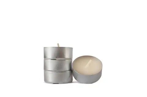 Stack of three unlit silver tealight candles, positioned adjacent to a single. Stock Photos