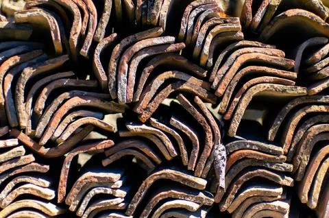 A stack of tiles, a clay roof, background and Stock Photos