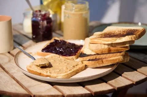 Stack Of Toast With Peanut Butter And Jelly On A Rustic Outdoor Table 写真素材