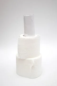 A stack of toilet paper rolls on white background Stock Photos