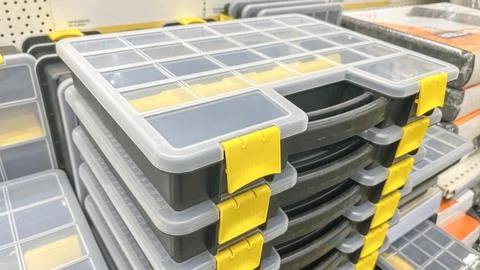 A stack of toolboxes with yellow handles. The boxes are black and white. The Stock Photos