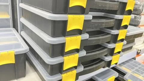 A stack of toolboxes with yellow handles. The boxes are black and white. The Stock Photos