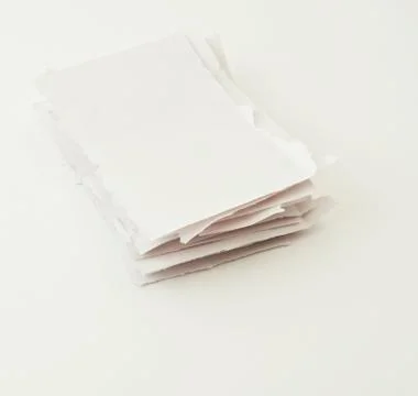 Stack of torn paper pieces over white Stock Photos