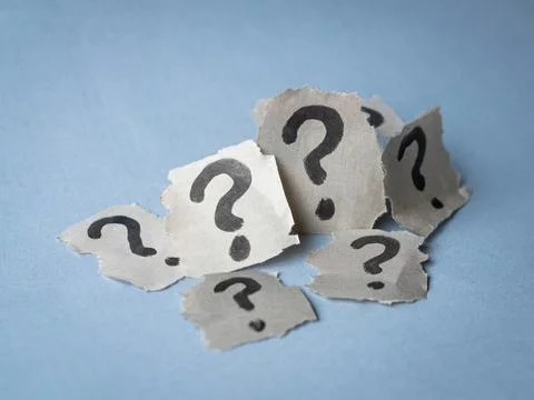 Stack of torn papers with question marks. Stock Photos