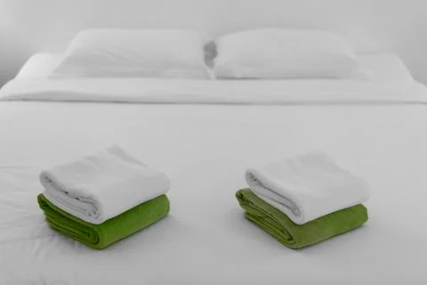 Stack towel set on bed in modern bedroom at hotel Stock Photos