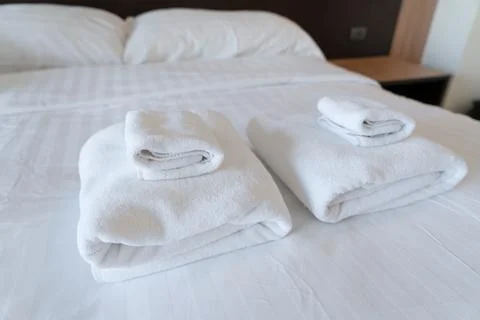 Stack towel set on bed in modern bedroom at hotel Stock Photos